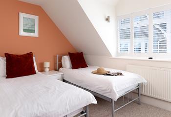 Bedroom 2 has twin beds, suitable for both adults and children.
