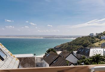 Gaze across the rooftops and out to sea, watching the ever-changing tide.