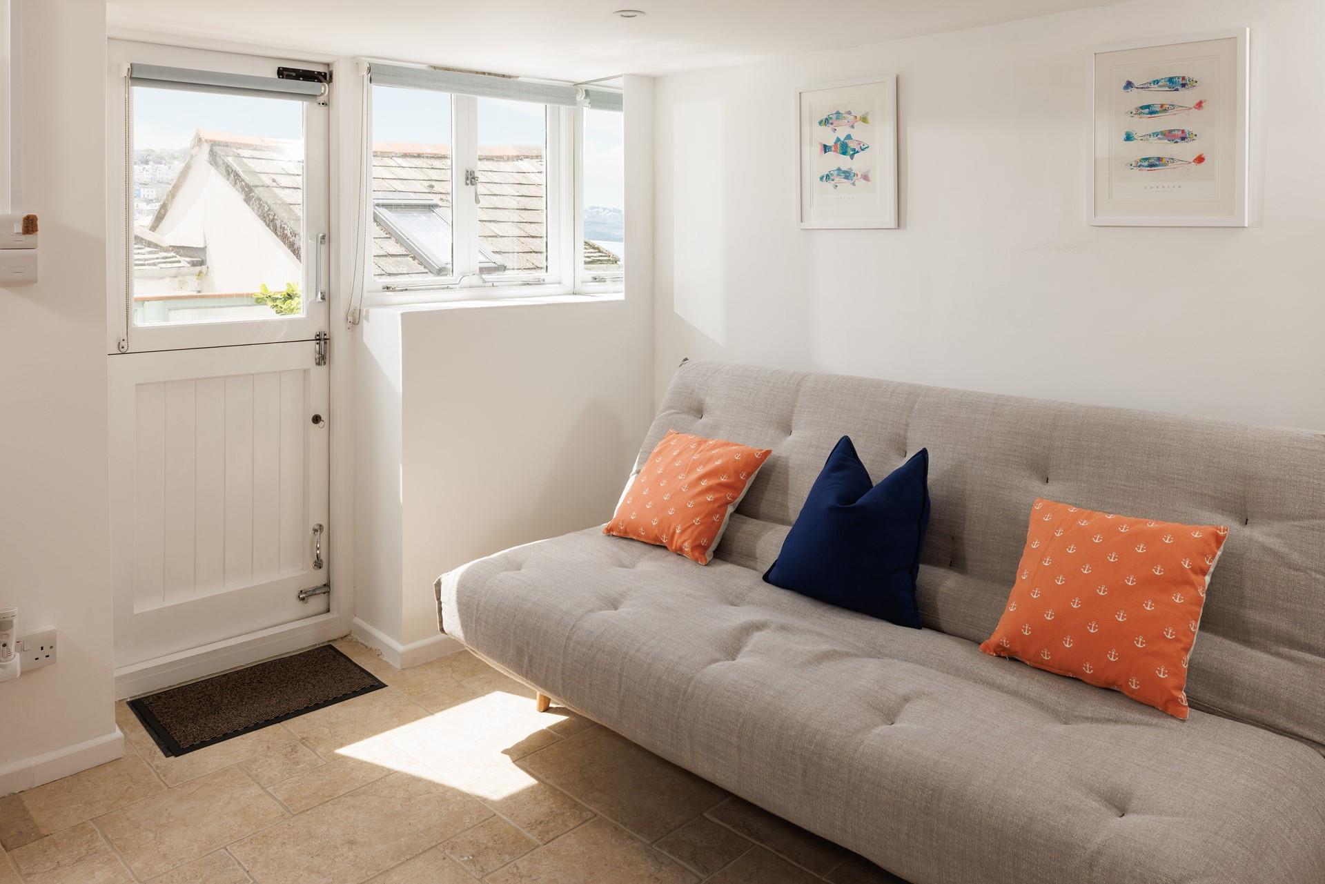 Curl up with a book and unwind on the sofa in the garden room. 