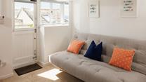 Curl up with a book and unwind on the sofa in the garden room. 