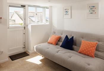 Curl up with a book and unwind on the sofa in the garden room. 