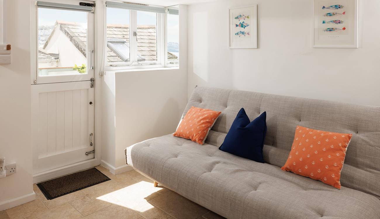 Curl up with a book and unwind on the sofa in the garden room. 