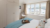 Open the curtains each morning to see the sun shining on the sea.