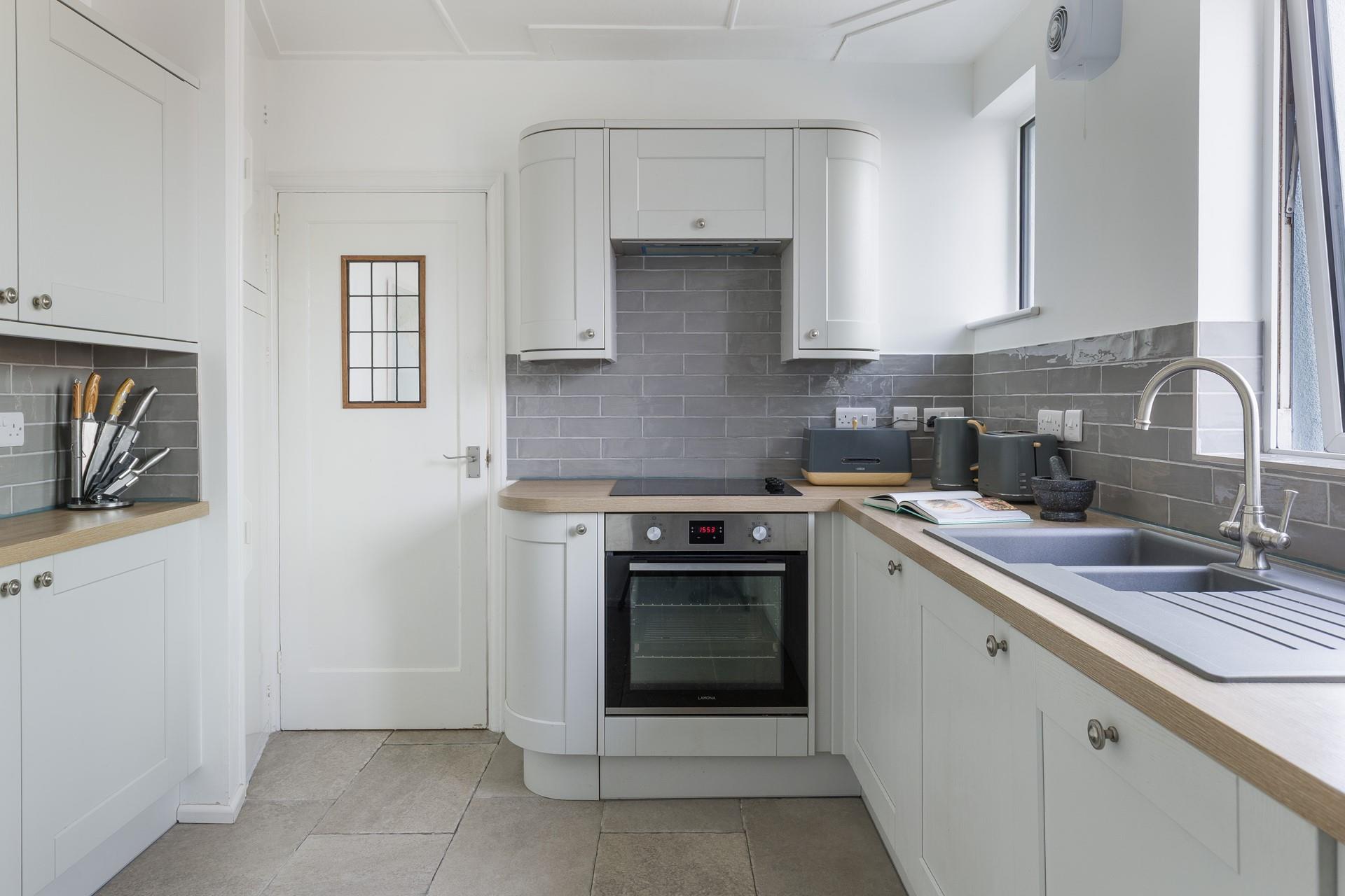 The modern kitchen is light and bright. 