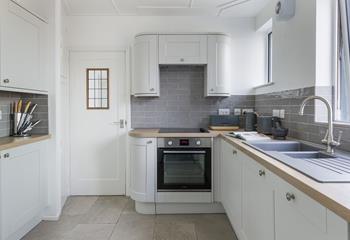 The modern kitchen is light and bright. 