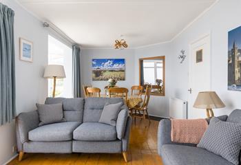 The comfortable living area boasts sea views from the sofa and dining table.