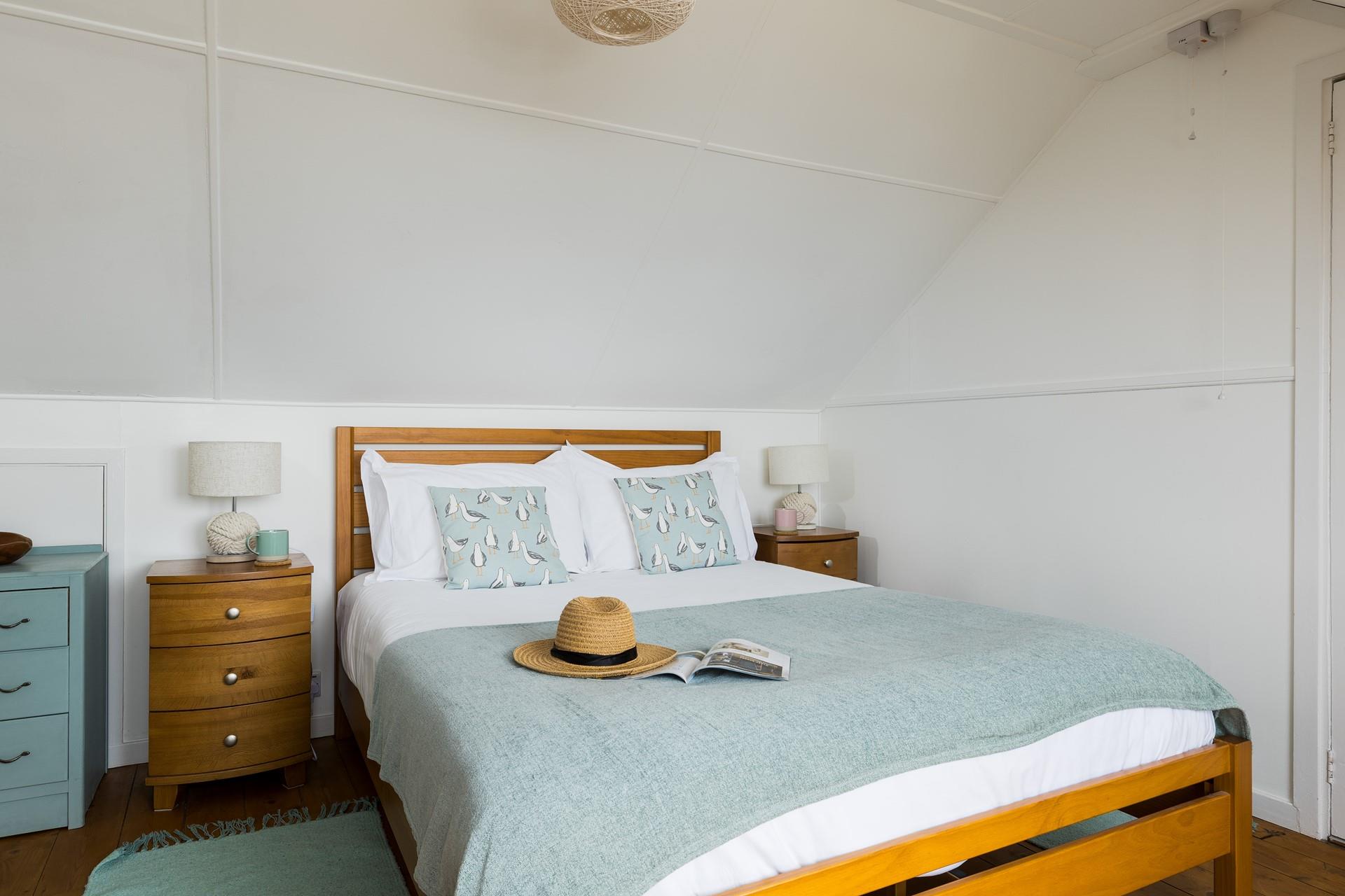 Bedroom 3 is decorated in calming coastal colours.