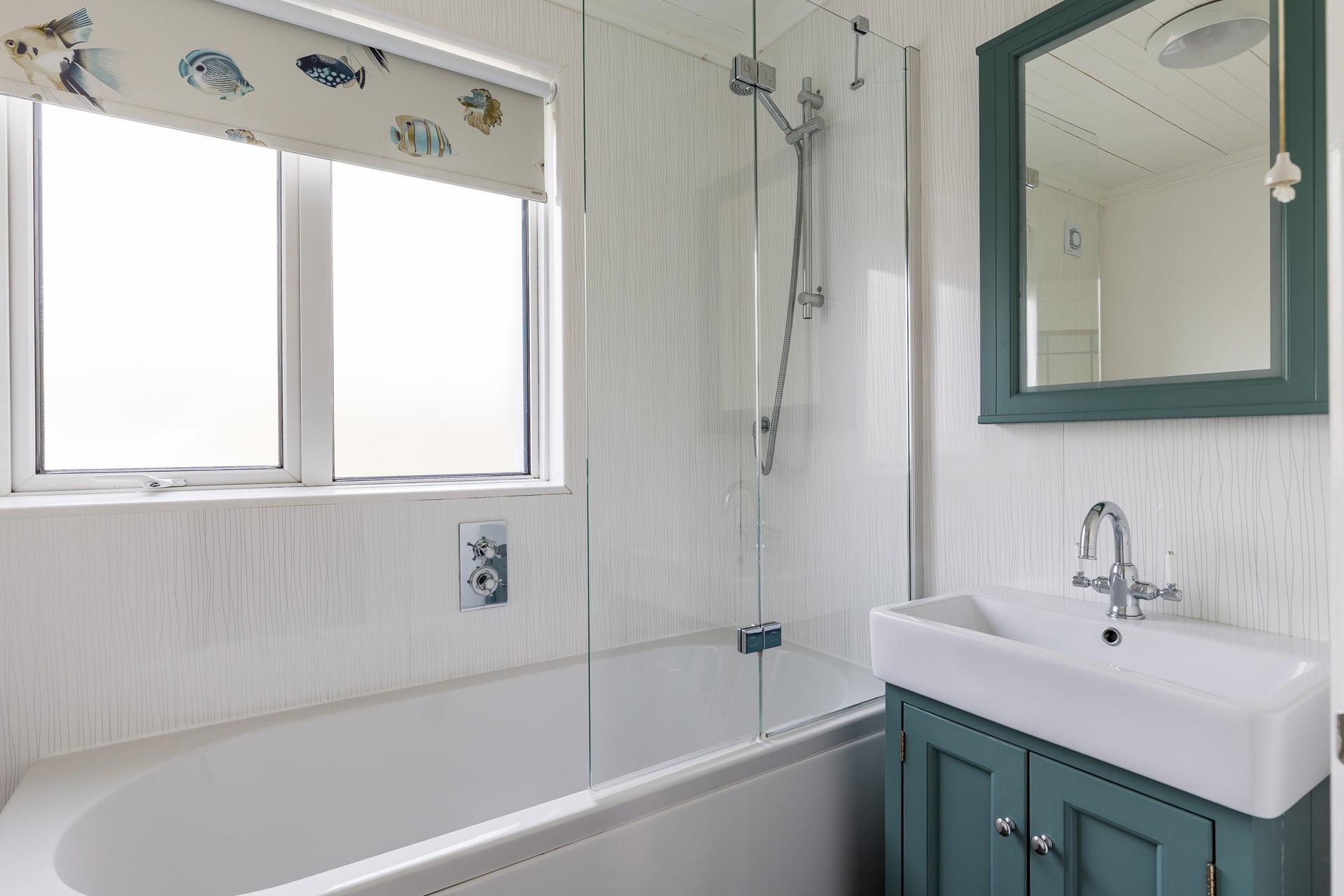 The family bathroom has a shower over bath, perfect for a quick rinse or relaxing soak.