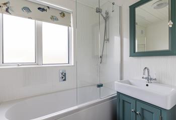 The family bathroom has a shower over bath, perfect for a quick rinse or relaxing soak.