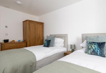 Bedroom 2 has twin beds and plenty of storage, suitable for adults or children.