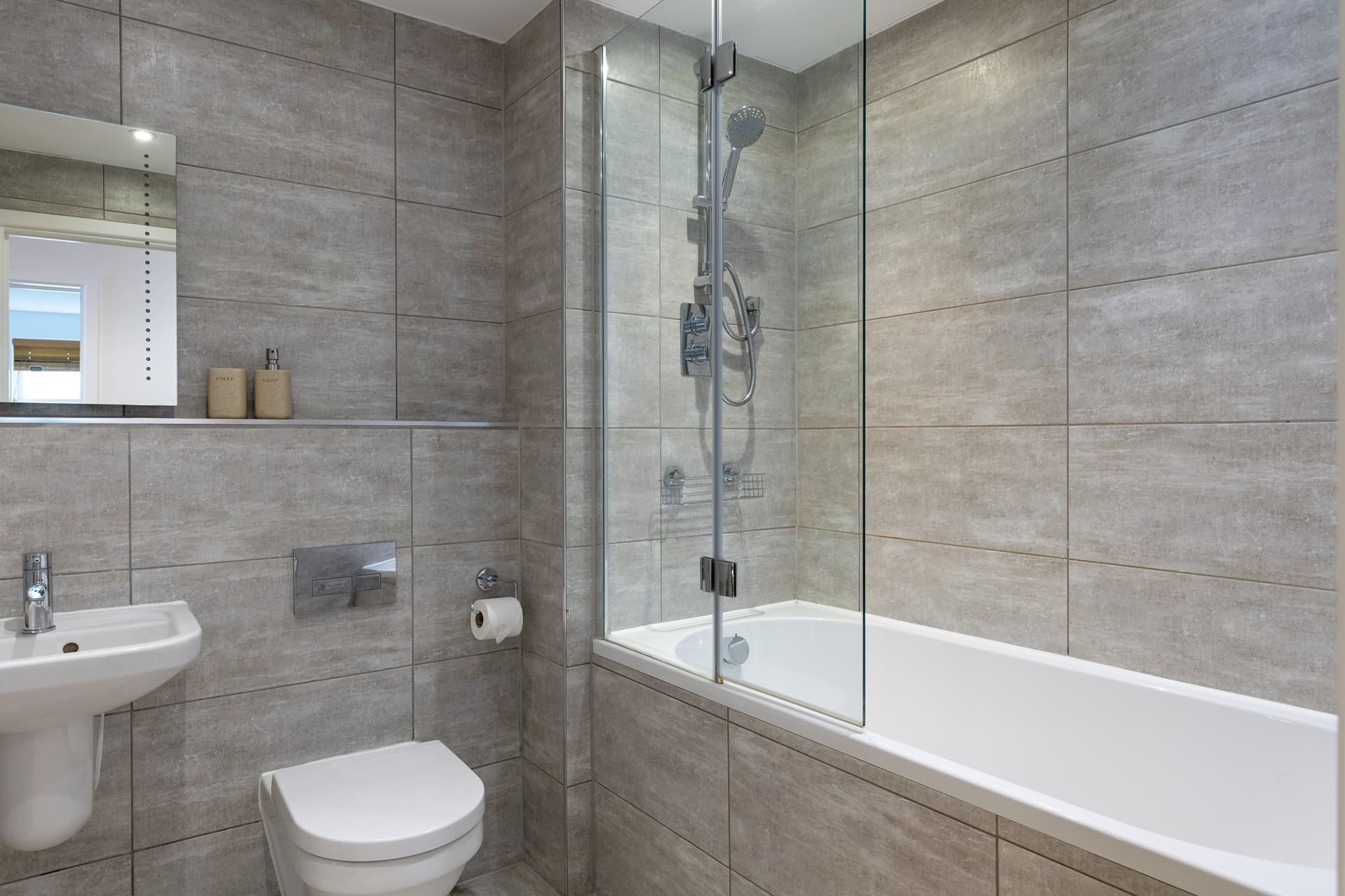The family bathroom has a shower over bath, just what you need after a busy beach day!