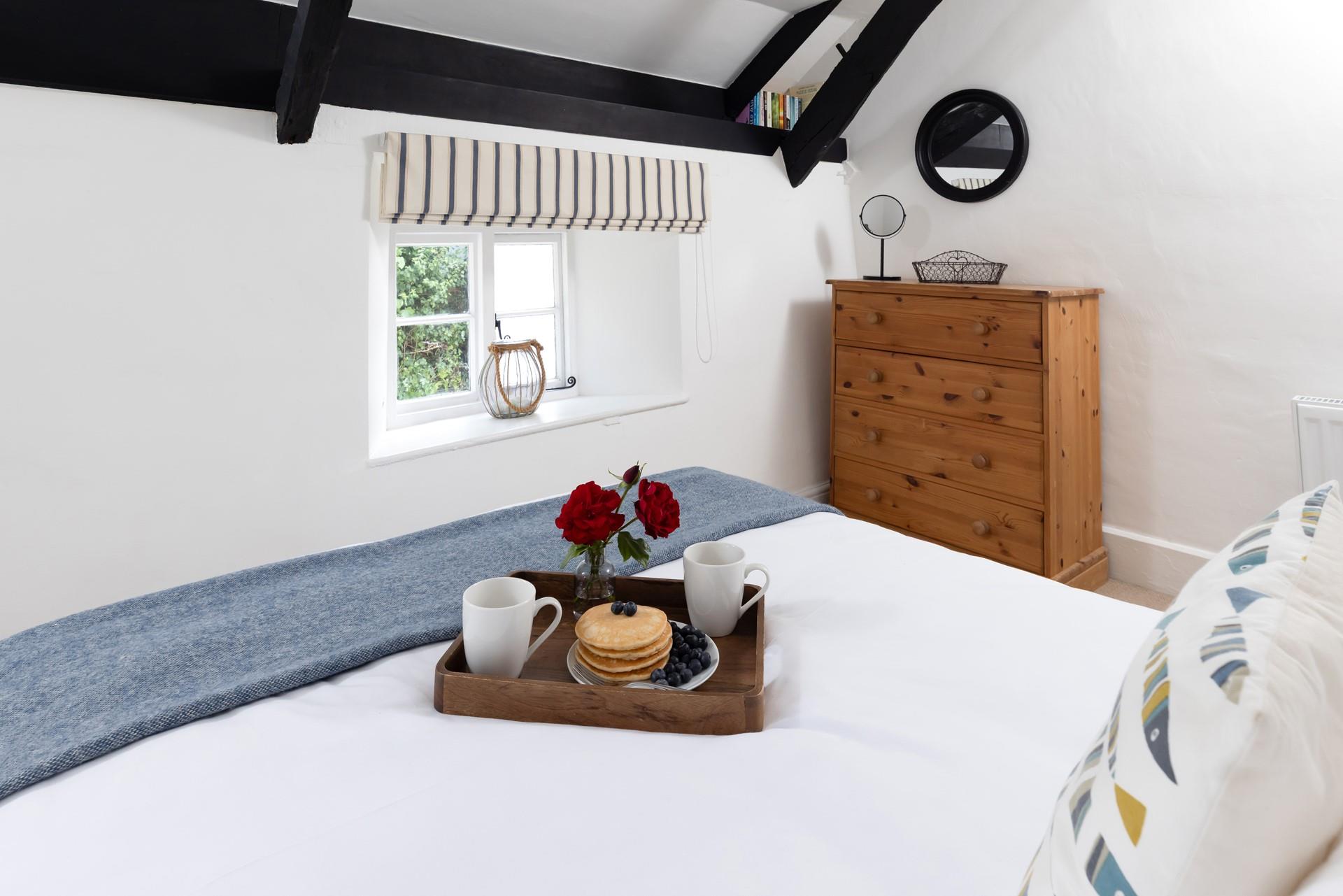 The bright bedroom is the perfect place to relax after a day of exploring. 