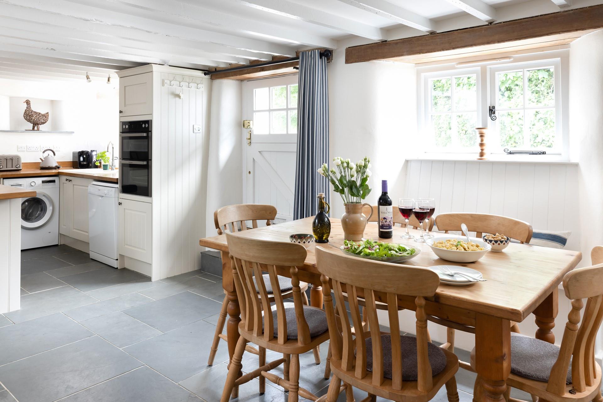 The open-plan kitchen and dining area is a social space, perfect for enjoying each other's company. 
