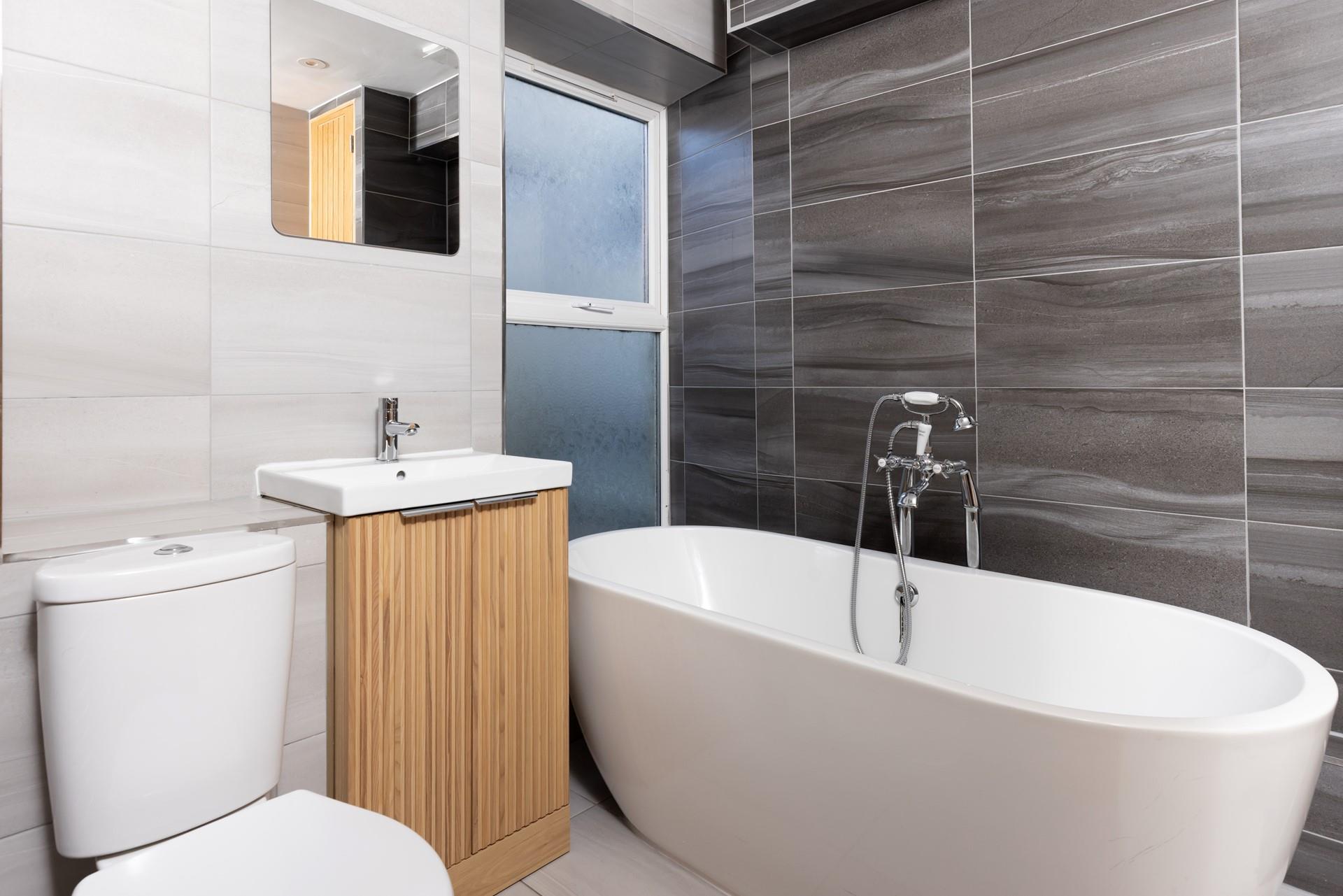 Soak in the stylish bath after a day of walking along the coast path.
