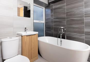 Soak in the stylish bath after a day of walking along the coast path.