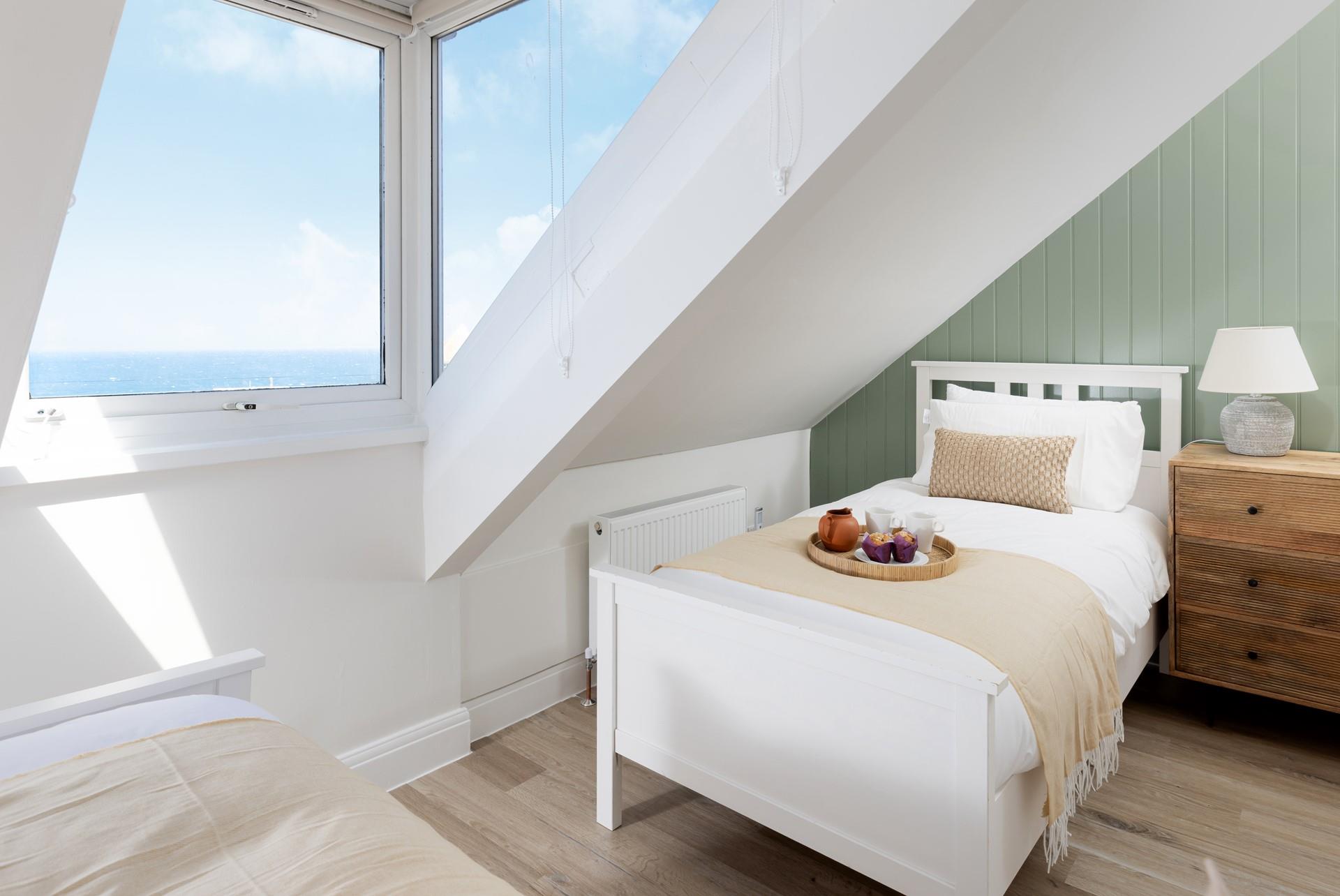 Wake up to sea views from the twin bedroom!