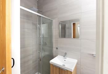 Step into the sleek en suite shower room.