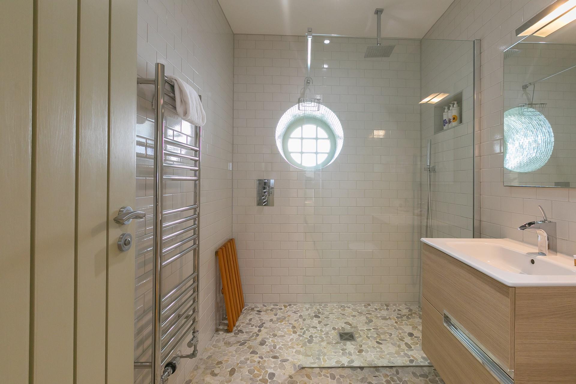 The family bathroom boasts a large walk-in shower.