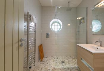 The family bathroom boasts a large walk-in shower.