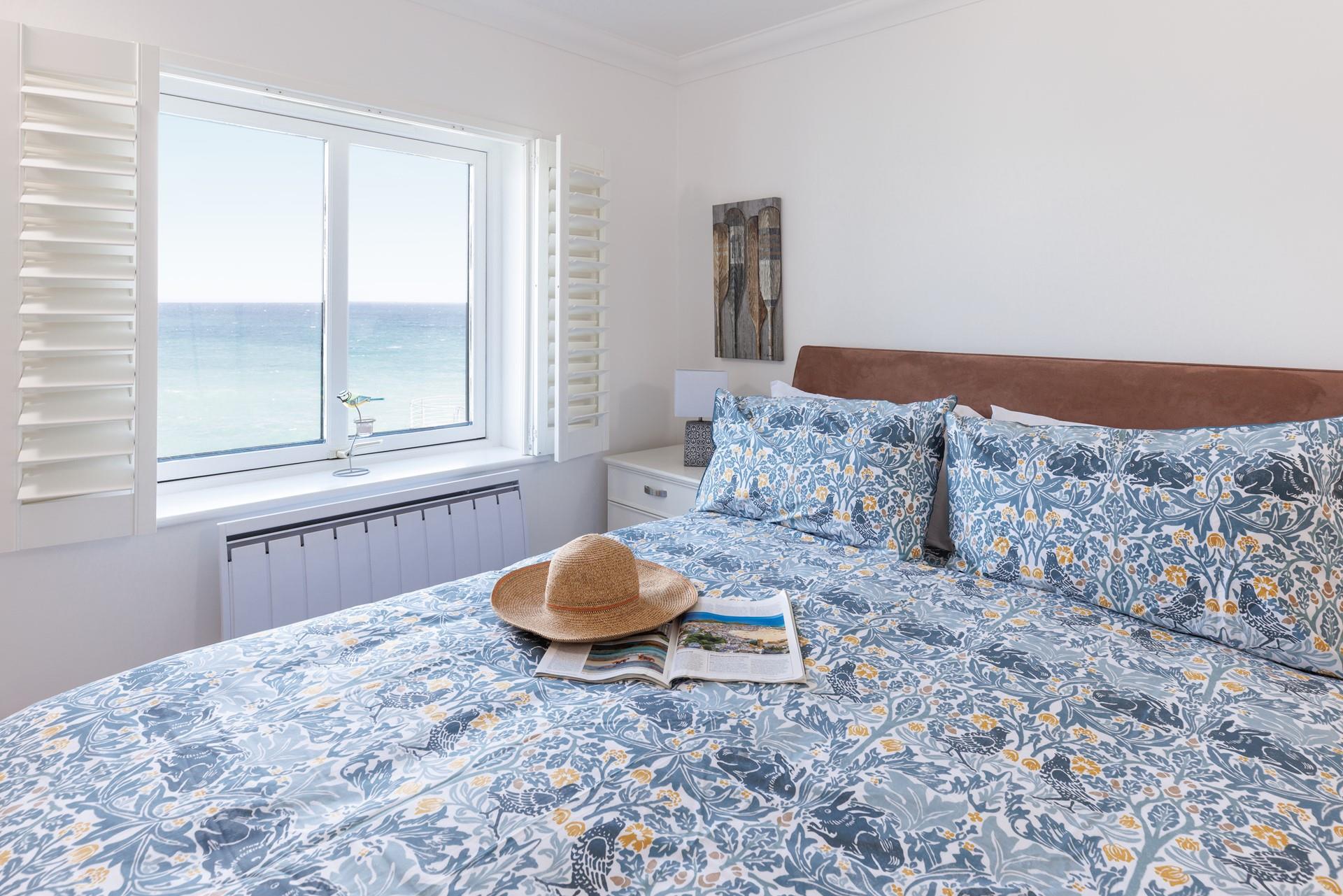 Open the blinds each morning to see the sun shining on the sea.