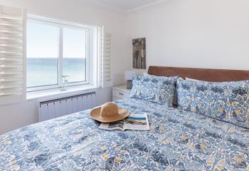 Open the blinds each morning to see the sun shining on the sea.