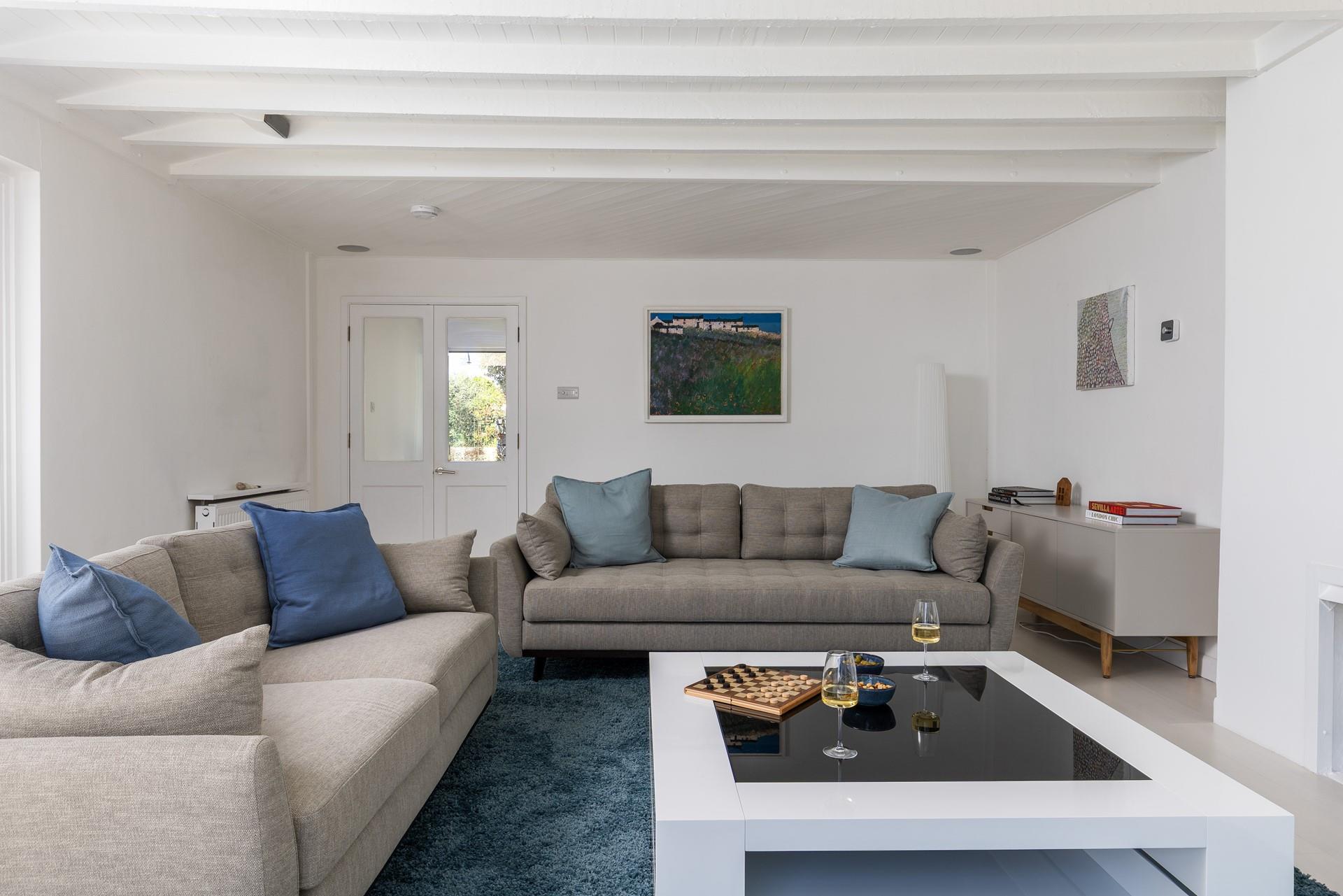 Unique artwork from Cornish painter John Dyer takes pride of place in the living area.