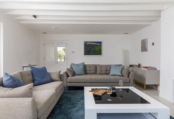 Unique artwork from Cornish painter John Dyer takes pride of place in the living area.
