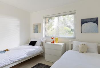 Bedroom 2 has twin beds and fun pops of colour.