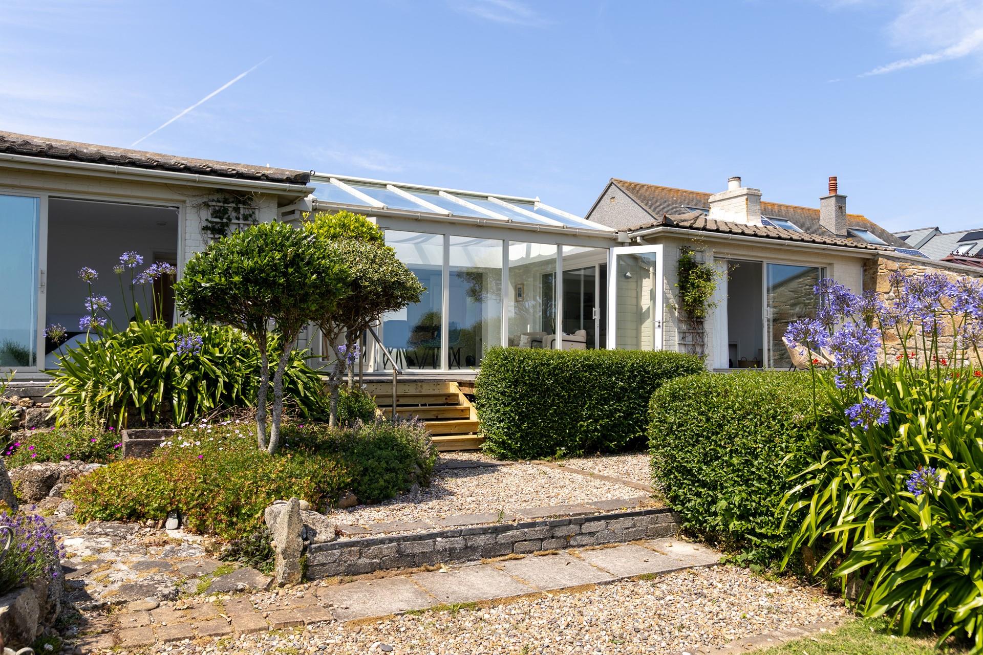 Step down into the bright and fragrant garden, bursting with colour.