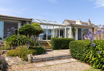 Step down into the bright and fragrant garden, bursting with colour.