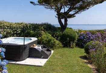 Nestled within the gardens is a luxurious hot tub!