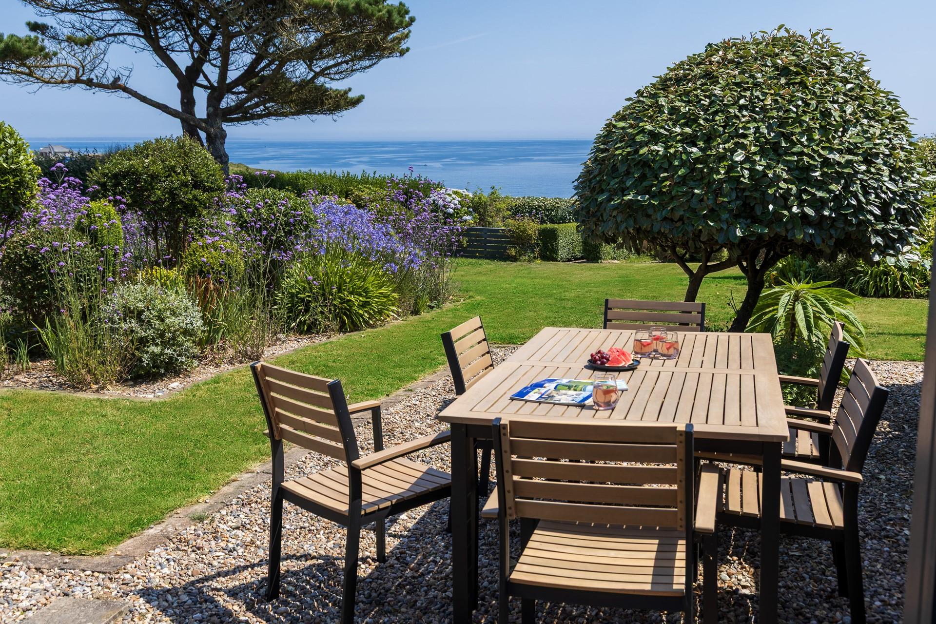 Sit back and admire all the colours of the garden, against the everchanging ocean blues.