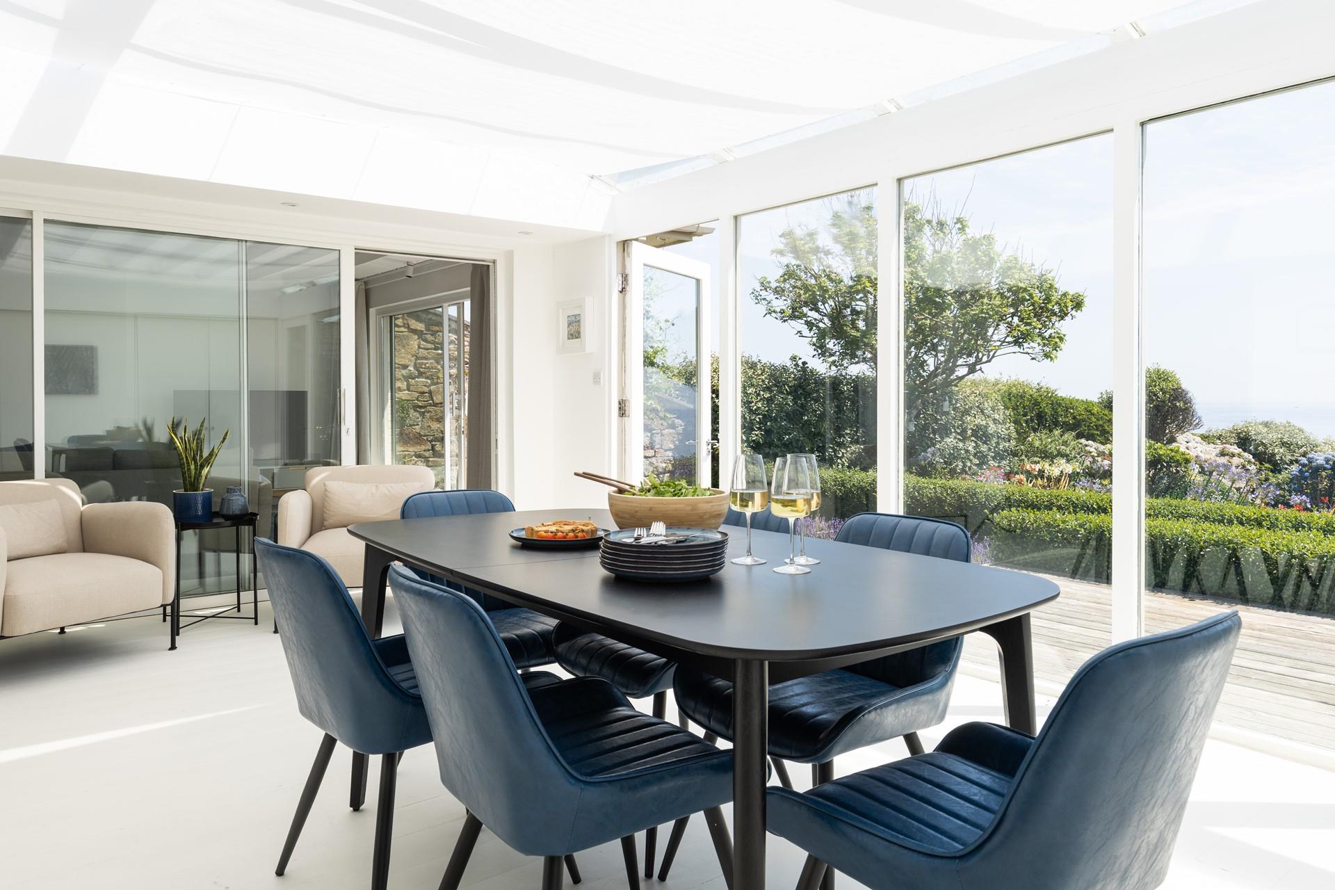 Gather together around the dining table with the coast as your backdrop.