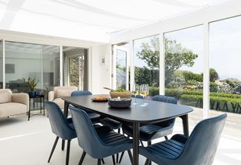 Gather together around the dining table with the coast as your backdrop.