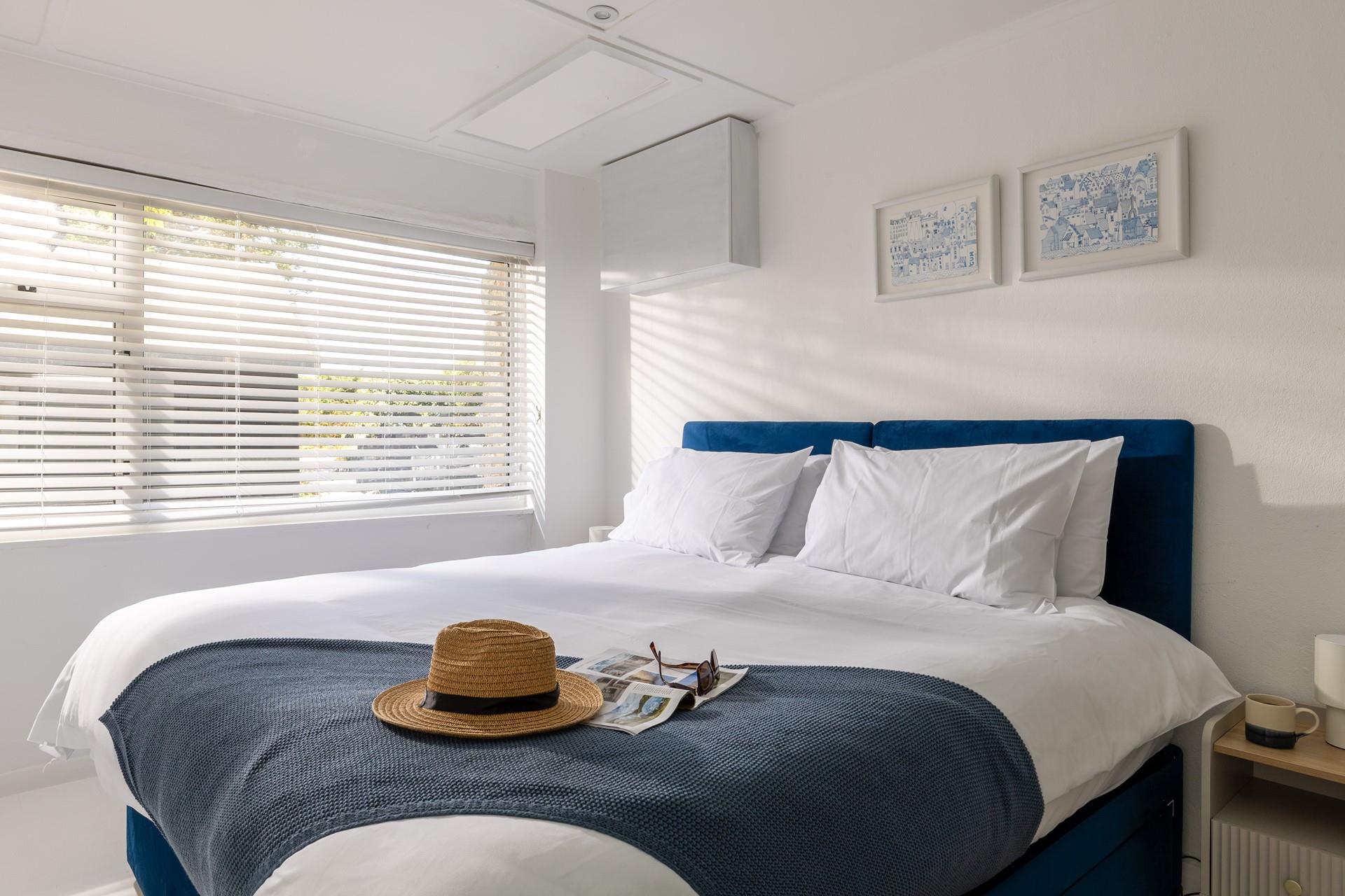 The stylish coastal blues create a relaxing haven in bedroom 3.