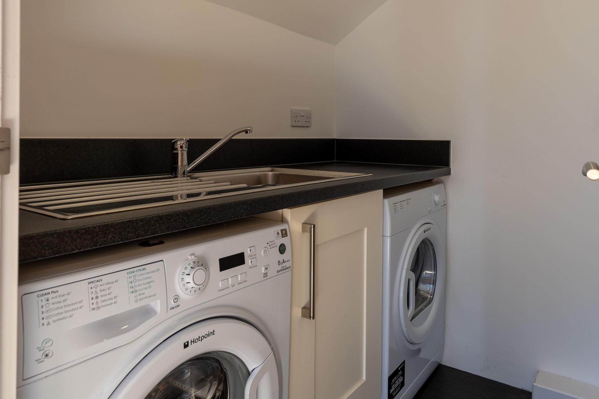 The apartment has a handy utility room, great for after beach days!