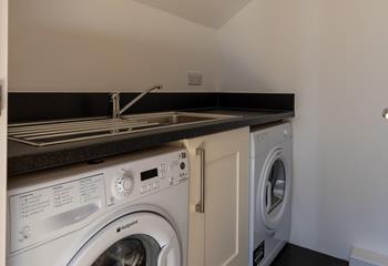 The apartment has a handy utility room, great for after beach days!