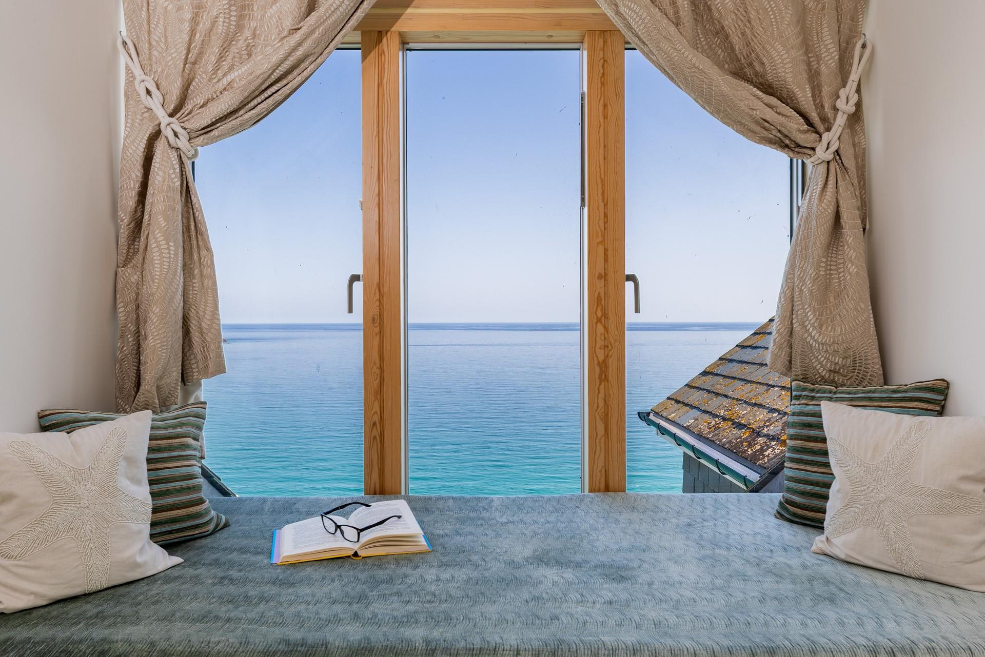 While away the hours curled up in the window seat watching the everchanging tide.