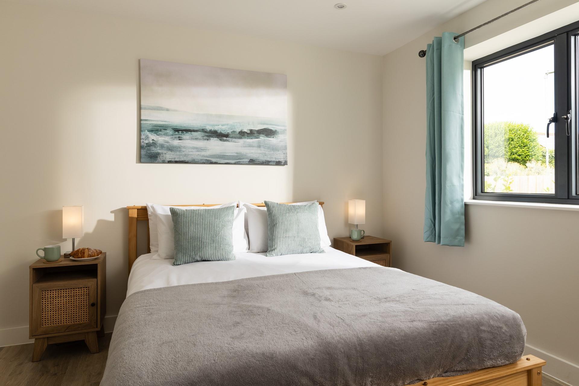 Bedroom 1 is decorated with calming coastal hues.
