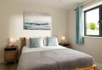 Bedroom 1 is decorated with calming coastal hues.