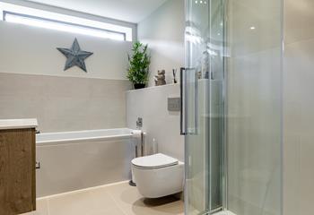 The contemporary family bathroom has a shower and bath.