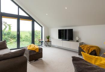 Floor-to-ceiling windows overlook the Cornish countryside.