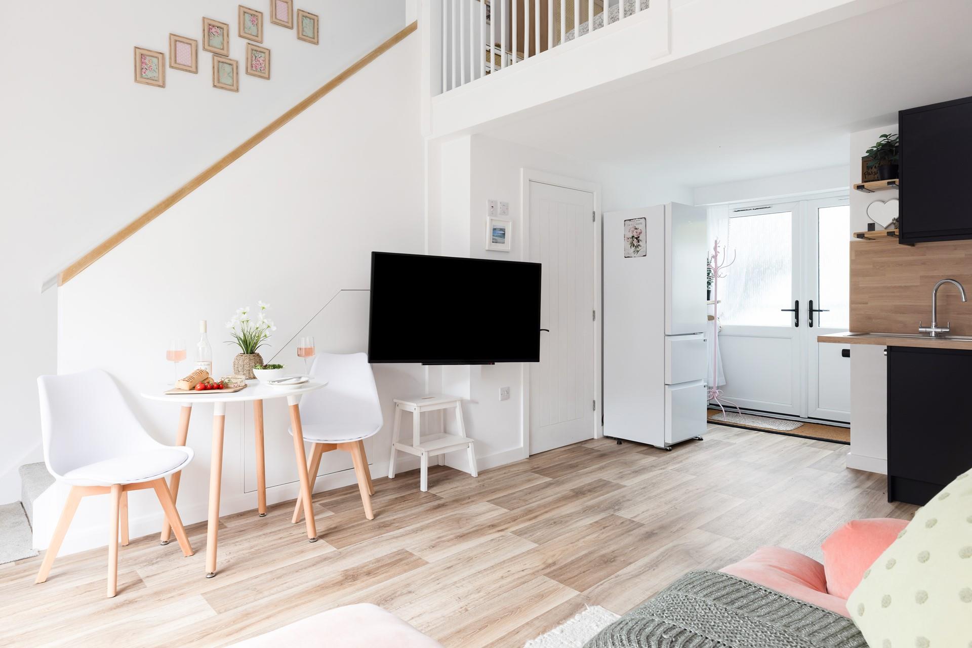 From the living area, steps up to the mezzanine bedroom.