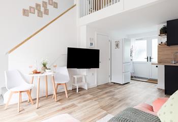 From the living area, steps up to the mezzanine bedroom.
