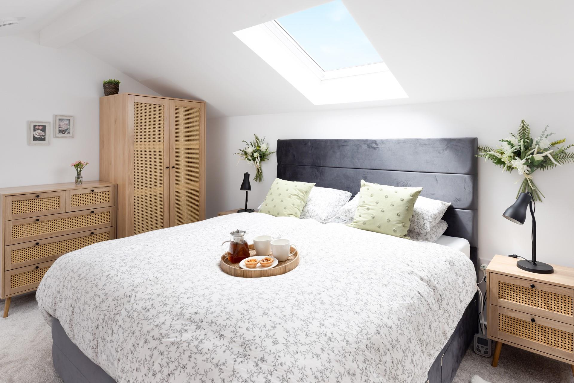 The light and bright mezzanine bedroom has a comfortable king size bed.