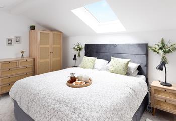 The light and bright mezzanine bedroom has a comfortable king size bed.