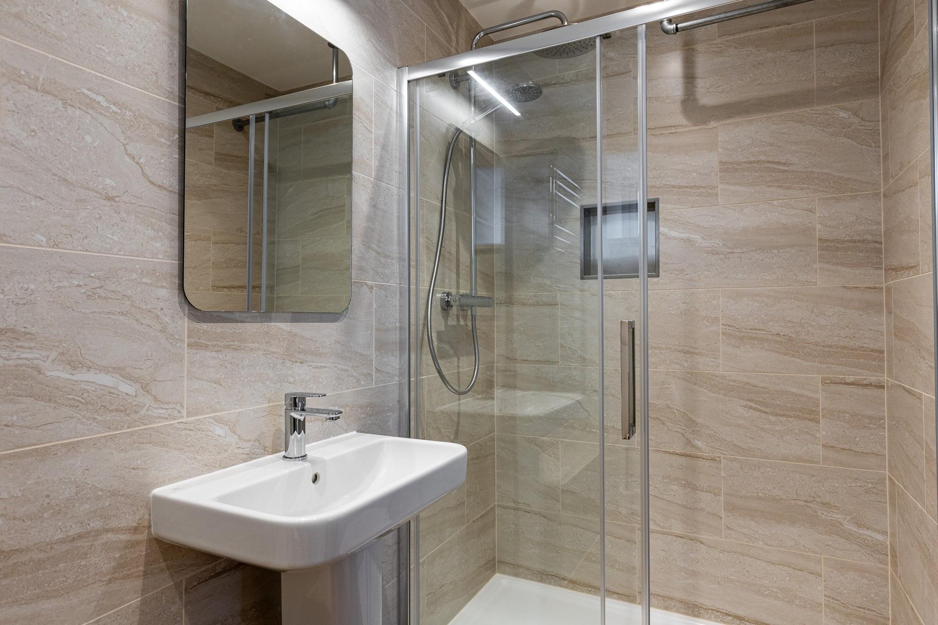 The en suite shower has a spa-like feel.