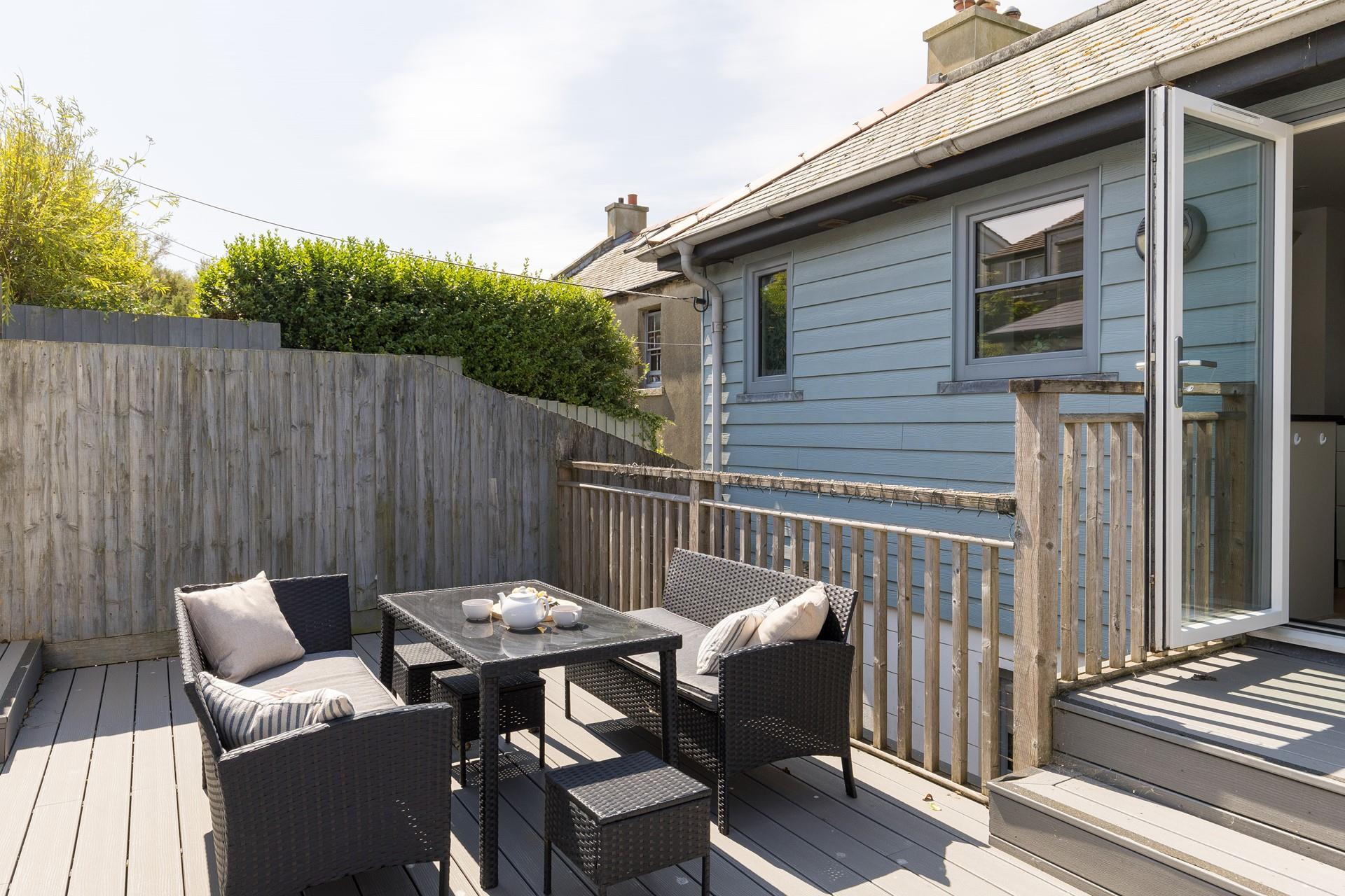 From the kitchen, step out onto the shared decked terrace.