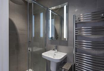The sleek and stylish en suite in bedroom 2 has a rainfall shower.