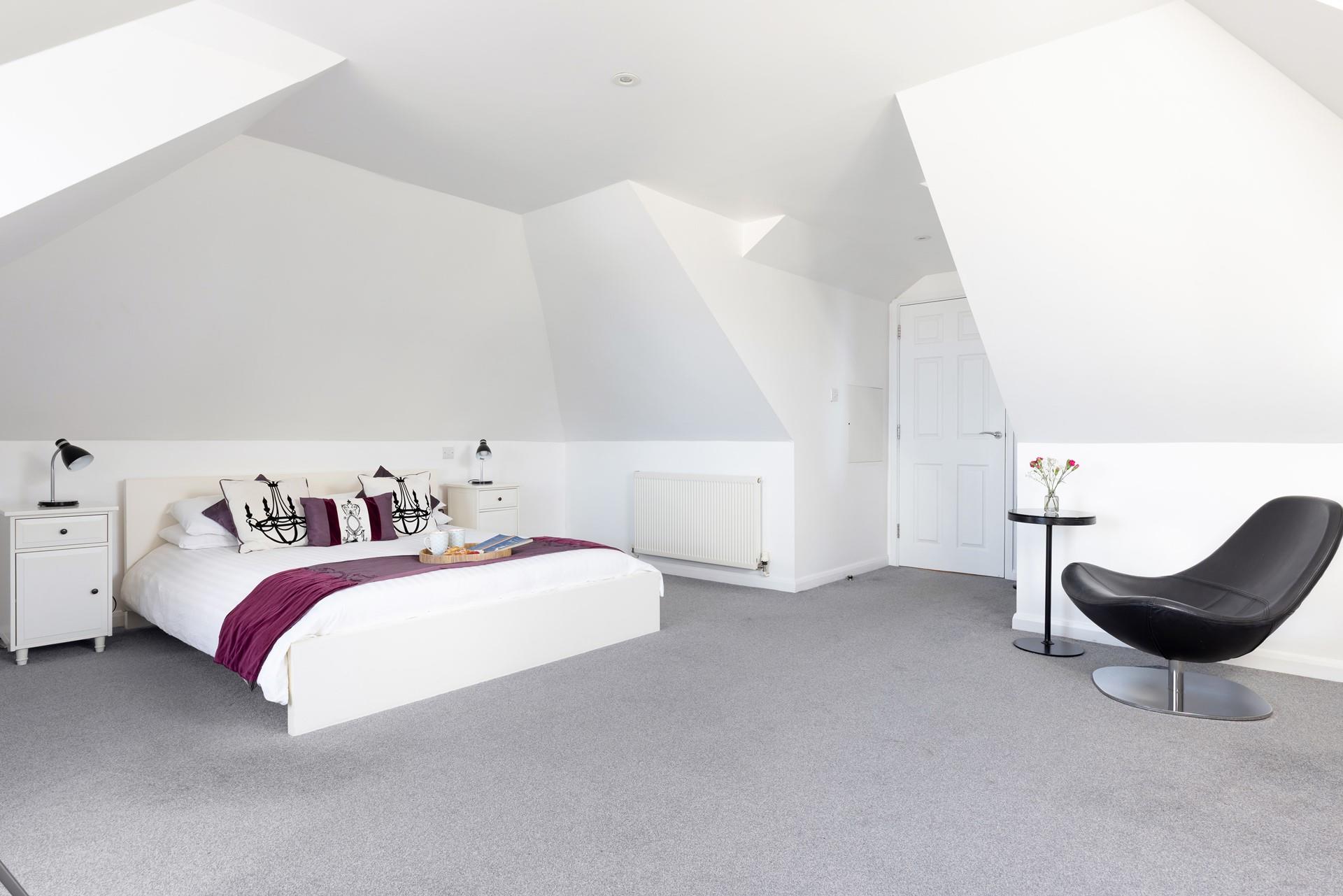 The king-sized bed is the perfect spot to enjoy a slow, peaceful morning. 